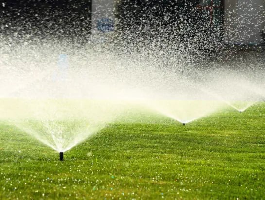 Sprinklers going off on a natural turf sport field