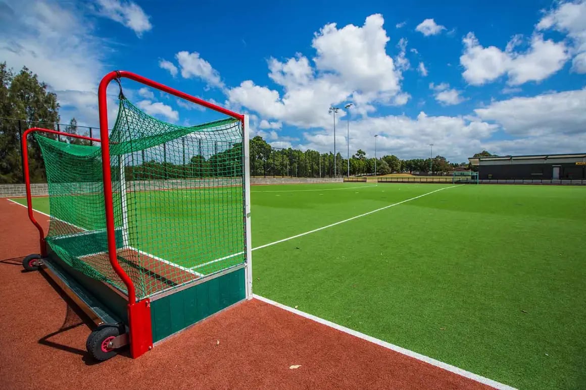Red hockey goal on outdoor synthetic turf sports field