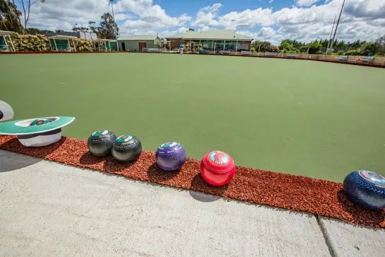 Lawn Bowls on the side of the field with hat