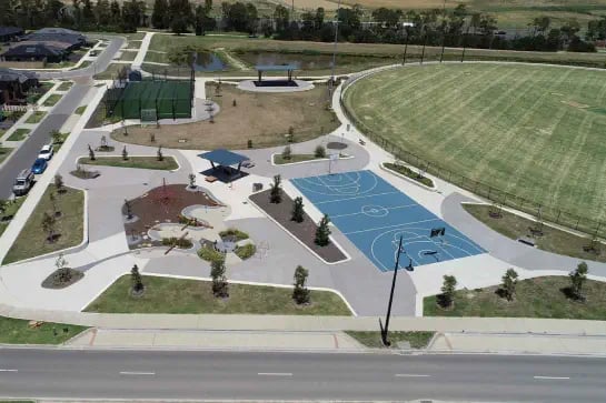 Aerial view of a multi use game area with AFL oval, cricket enclosure and netball field of play