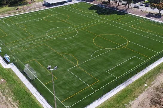 Aerial view of an outdoor soccer sports field with synthetic turf surface