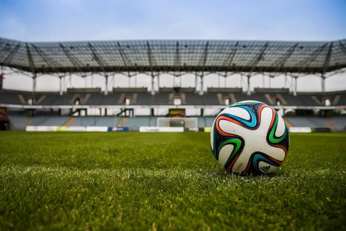 Close up of a soccer ball on a natural turf soccer sports field in a stadium