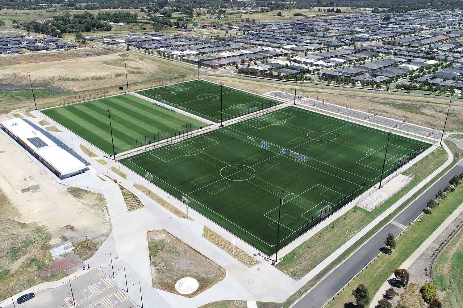 Aerial view of four soccer sports fields with natural turf and hybrid turf surfaces